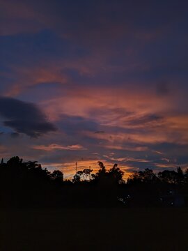 The beauty of sunrise on a field with mountains and clouds in the background