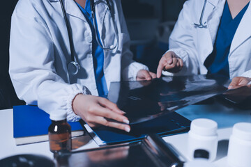 Male and female doctors are having a meeting in a hospital room.