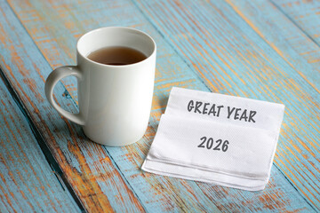 Great year 2026 on white napkin, next to cup of coffee. 