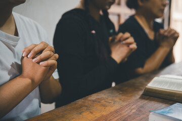 Praying religion, worship and group of people pray to God, Family, holding hands and prayer in home...