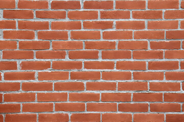 A wall with brown and orange bricks. Vintage bricks and outdoor wall. Construction industry and cement with bricks. Background for presentation. Bricks backdrop.