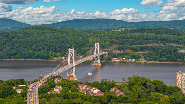 Poughkeepsie New York, arial drone view overlooking the Mid Hudson Bridge with serene hills in background on a perfect late Spring to early Summer day.