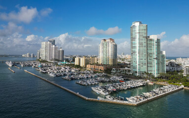 Fototapeta premium Docked yacht in port of Miami. Marina luxury cityscape. Port with yacht. Yachting marina. Luxury yacht charter. Miami port marina. Luxury yachting in summer. Charming marina