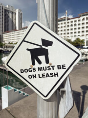 Dogs must be on leash sign near marina in Penang, Malaysia promotes responsible pet ownership