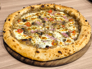 Delicious Pizza Topped with Ham and Vegetables