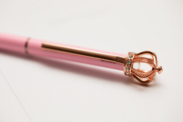 a pink queen pen on a white background