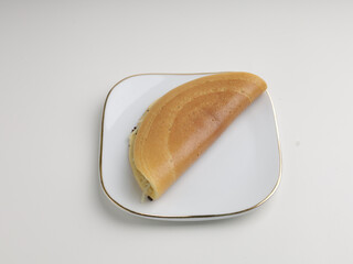 Folded crepes on white plate