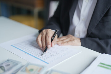 Fototapeta premium Businesswoman Accountant analyzing investment charts Invoice documents. Accounting Bookkeeper Clerk&nbsp;Bank Advisor And Auditor