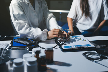 Cropped image of male doctor's hand using stethoscope to examining heartbeat and symptom of patient while talking