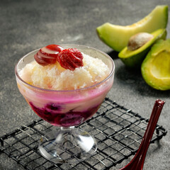 Vanilla ice cream with strawberry syrup and fresh fruit pieces