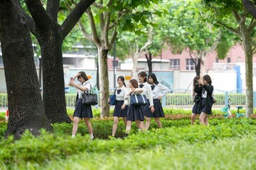 In early June in Pudong, Shanghai, seven Japanese high school girls wearing summer uniforms are...