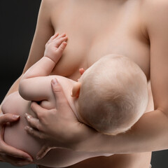Mother breastfeeding newborn in a serene indoor setting during daytime