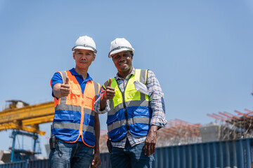 Happy Construction Workers Giving Thumbs Up, Confident Engineers or Builders at Project Site, Successful Team of Professionals in Safety Gear