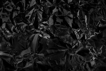 Shiny black grey foil metal texture, abstract wrapping paper for background and design art work.