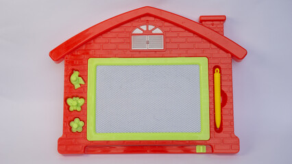 Colorful magnetic drawing board toy for kids shaped like a house. Includes a stylus and fun shapes...