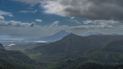 Beautiful mountain panorama. View from the height. Thickets of green forest on the slopes. Lakes in...