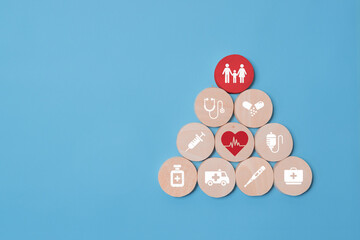 Health insurance concept, wooden blocks with healthcare medical icon, blue background