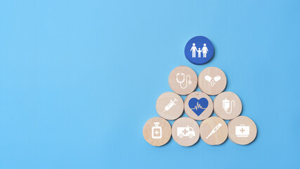 Health insurance concept, wooden blocks with healthcare medical icon on blue background