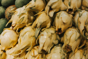 Yellow pitahaya on the counter in the store close-up. Exotic fruits in the fruit section of the supermarket