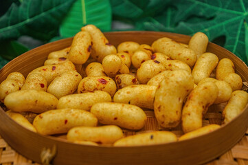 A vibrant arrangement of spicy Indonesian crackers, artfully presented in a traditional woven...