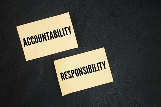 Paper with the words accountability and responsibility. Accountability refers to being responsible or liable for actions, decisions, and their consequences.