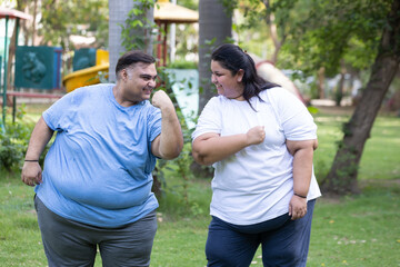 Obraz premium Fat indian couple teaming up to lose weight, Body positive plus size man and woman have fun outdoors. Overweight people fitness and health care. Obesity india. Determination and motivation Challenge.