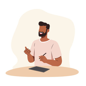 A man is doing creative design work with gadget on the table