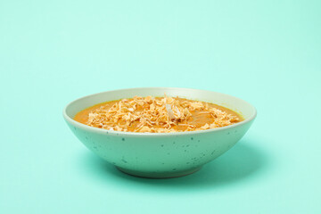 Sweet potato puree in bowl on green background