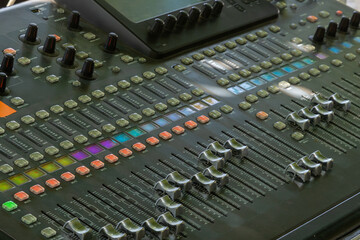 Professional audio mixer showing faders and knobs for sound engineering