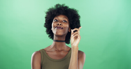 Black woman, thinking or solution with afro on green background for problem solving in studio. Female person, thinker and African model with good decision for idea, question or answer on mockup space