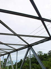 View of bridge frame with cloudy sky in the background. 