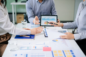 Businessman and team analyzing financial statement Finance task. with smart phone and laptop and  tablet.