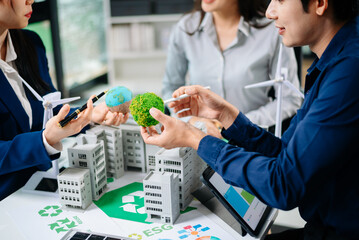 Professionals for a greener future. Showcasing renewable energy solutions with solar panels, wind turbines, and a model house...