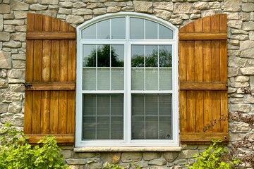 arched window with wooden shutters