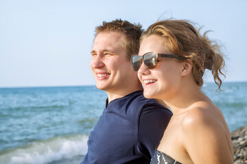 Portrait of a young couple on the background of the sea. Rest on the shore of the warm sea. Close-up