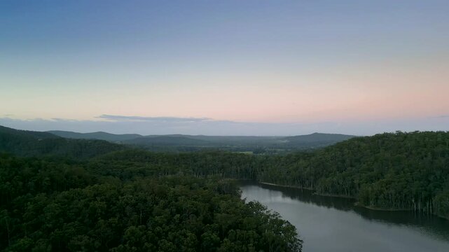 Sunsets over a damn on the Gold Coast hinterland with the City in the background.