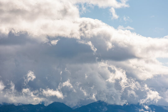 heavy clouds on a blue sky above mountains september. dramatic view. early autumn cloudy weather over carpathian range. cloudscape vacation
