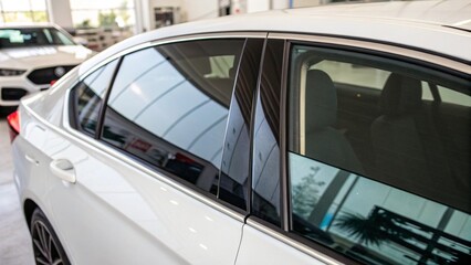 Obraz premium Luxury automobiles lined up in a bustling city parking lot, ready for a wash or to hit the road
