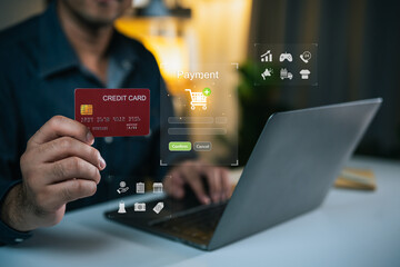 Hands holding credit card for online payment with laptop, e-commerce concepts and shopping cart on screen, digital transaction and technology usage