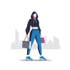 a woman in a trendy outfit carrying a designer shopping bag