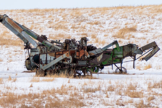 Collection of threshing machines in a snowy field North Dakota