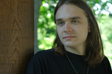 Young man reflecting quietly in a serene natural setting