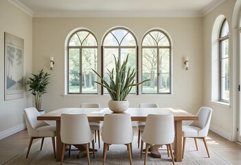 Fototapeta premium Calming dining space with a rectangular oak table, soft white chairs, tall cactus in a ceramic planter, and light flooding in through arched windows.