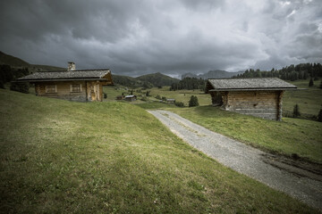 small house over a mountain pasture in Dolomites with wonderful panorama