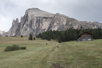 small house over a mountain pasture in Dolomites with wonderful panorama