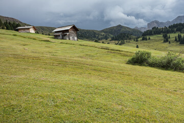 small house over a mountain pasture in Dolomites with wonderful panorama