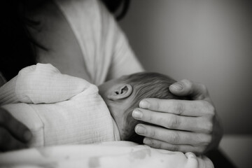 Mother Breastfeeding Newborn Baby with Care and Tenderness