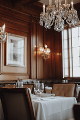 Luxurious fine dining restaurant featuring elegant wooden décor, crystal chandeliers, and an intimate setting for a memorable culinary experience
