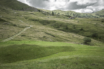 small house over a mountain pasture in Dolomites with wonderful panorama