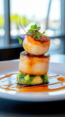 Elegant gourmet dish featuring perfectly seared scallops stacked on greens, finished with a drizzle of sauce.